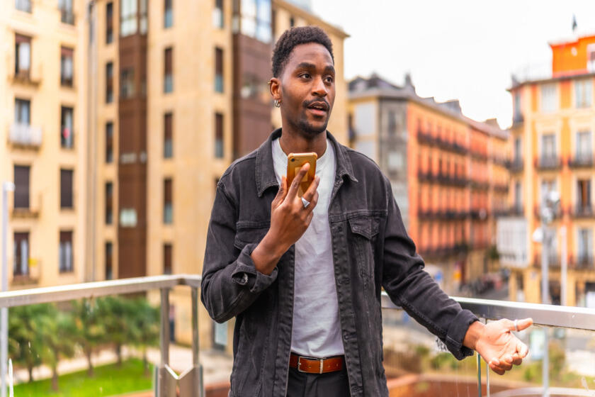 Man recording voice memo to save writing ideas on the go