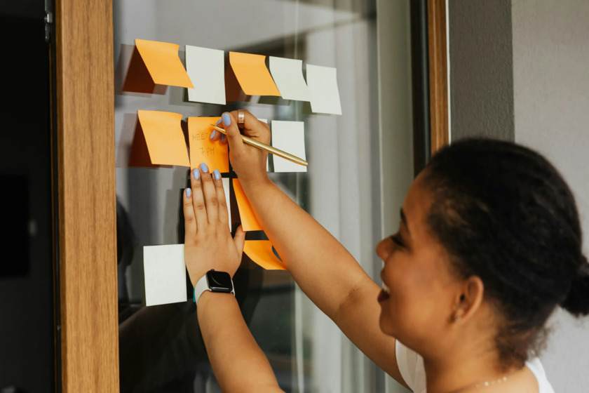 Writer planning a novel structure using sticky notes